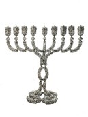 בתמונה המוצגת: חנוכיה מרשימה במיוחד עשויה כסף טהור ברקמת פיליגרין עשירה, דגם נשיאים מבית האומן גרשי. רוחב החנוכיה 57 ס"מ, קוטר הבסיס 25.5 ס"מ, גובה החנוכיה: 54 ס"מ